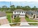Aerial view of a two-story home with a three-car garage and a brick-paved driveway at 14384 Alafaya Oak Bnd, Orlando, FL 32828