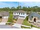 Aerial view of a two-story home showcasing mature landscaping, a long driveway, and well-manicured lawn at 14384 Alafaya Oak Bnd, Orlando, FL 32828