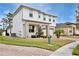 Two-story home with brick driveway and well-maintained lawn with mature landscaping at 14384 Alafaya Oak Bnd, Orlando, FL 32828