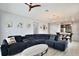 Open-concept living room featuring a large sectional sofa, pendant lights, and light wood-look floors at 14384 Alafaya Oak Bnd, Orlando, FL 32828