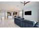 Open-concept living space with modern furnishings, a large television, and adjacent kitchen at 14384 Alafaya Oak Bnd, Orlando, FL 32828