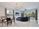 Open-concept living area with natural light, modern furniture, and a view of the pool at 14384 Alafaya Oak Bnd, Orlando, FL 32828