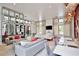 Bright community lounge area with modern furniture, shelving, and large windows at 14384 Alafaya Oak Bnd, Orlando, FL 32828