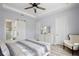 Relaxing bedroom with wood-look floors, tray ceilings, with a sliding door leading to the bathroom at 14384 Alafaya Oak Bnd, Orlando, FL 32828