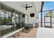 Enclosed patio with brick floors, ceiling fan, a refrigerator, tv, and black metal furniture at 14384 Alafaya Oak Bnd, Orlando, FL 32828