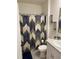 Bright bathroom featuring a vanity with a sink, toilet, and decorative shower curtain at 1548 Planters Point Rd, Kissimmee, FL 34744