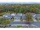 Aerial view of townhomes, showing the roofs, garages, driveways, and surrounding greenery at 1562 Travertine Ter, Sanford, FL 32771