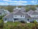 Aerial view of the home's backyard and surrounding area with lush greenery and a wooden fence at 1562 Travertine Ter, Sanford, FL 32771