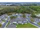 Aerial view of townhomes with well-manicured lawns, mature trees, and a surrounding landscape at 1562 Travertine Ter, Sanford, FL 32771