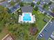 Aerial view of community pool, playground, and surrounding landscape and parking at 1562 Travertine Ter, Sanford, FL 32771