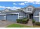 Charming two-story home featuring a blue gray exterior with well maintained landscaping at 1562 Travertine Ter, Sanford, FL 32771