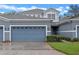 Charming two-story home featuring a blue gray exterior and a two car attached garage at 1562 Travertine Ter, Sanford, FL 32771
