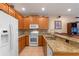Kitchen featuring light wood cabinets, tile backsplash, and stainless steel appliances at 1562 Travertine Ter, Sanford, FL 32771
