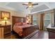 Spacious main bedroom with a ceiling fan and tray ceiling, complemented by dark wood floors at 1562 Travertine Ter, Sanford, FL 32771
