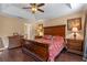 Comfortable main bedroom features a ceiling fan, dark wood floors, and ample natural light at 1562 Travertine Ter, Sanford, FL 32771
