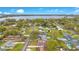 Aerial view of the neighborhood with mature trees and a glimpse of the lake in the distance at 1612 Idaho Ave, Belle Isle, FL 32809