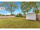 Spacious backyard featuring a shed and mature trees at 1612 Idaho Ave, Belle Isle, FL 32809