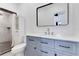 Beautiful bathroom with modern vanity, framed mirror, and tiled shower with new fixtures at 1612 Idaho Ave, Belle Isle, FL 32809