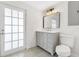 Charming bathroom featuring a vanity with countertop and a bright light fixture above the mirror at 1612 Idaho Ave, Belle Isle, FL 32809