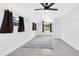 Cozy bedroom featuring two ceiling fans, natural light, and grey tile floors at 1612 Idaho Ave, Belle Isle, FL 32809
