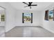 Bedroom featuring natural light, grey tile floors, modern ceiling fan, and a sliding mirror door at 1612 Idaho Ave, Belle Isle, FL 32809