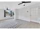 Well-lit bedroom featuring two ceiling fans, natural light, and grey tile floors at 1612 Idaho Ave, Belle Isle, FL 32809