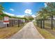 Scenic community boat ramp featuring a gated entrance and pathway to the water at 1612 Idaho Ave, Belle Isle, FL 32809