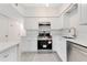 Modern kitchen featuring stainless steel appliances, sleek countertops and white cabinets at 1612 Idaho Ave, Belle Isle, FL 32809