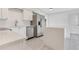 Modern kitchen featuring stainless steel appliances, white cabinetry, and a quartz countertop island at 1612 Idaho Ave, Belle Isle, FL 32809