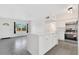 Open-concept living space featuring a kitchen island and modern appliances at 1612 Idaho Ave, Belle Isle, FL 32809