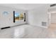 Bright living room featuring stylish tile floors, a large window, and freshly painted white walls at 1612 Idaho Ave, Belle Isle, FL 32809