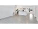 Open living space with new tile floors, seamlessly connecting the living area to the kitchen at 1612 Idaho Ave, Belle Isle, FL 32809