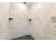 Updated walk-in shower featuring stylish tilework, built-in shelving and modern fixtures at 1612 Idaho Ave, Belle Isle, FL 32809