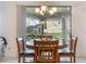 Dining area with chandelier lighting, sliding glass doors, and view of the outdoor space at 16328 Rock Coast Dr, Winter Garden, FL 34787