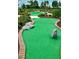 Fun mini-golf course with winding pathways, lush greenery, and playful rock features, perfect for Gathering entertainment at 16328 Rock Coast Dr, Winter Garden, FL 34787