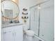 Modern bathroom with granite countertops, decorative shelving, and a glass-enclosed walk-in shower at 1636 Barberry Dr, Kissimmee, FL 34744