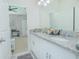 Bathroom with double vanity, granite countertops, and ample storage space at 1636 Barberry Dr, Kissimmee, FL 34744