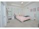 Bright bedroom with soft carpet, ample natural light, and a comfortable bed with stylish decor at 1636 Barberry Dr, Kissimmee, FL 34744