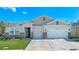 Charming single-Gathering home featuring a well-manicured lawn, two-car garage, and beautiful stone accents at 1636 Barberry Dr, Kissimmee, FL 34744