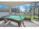 Bright game room with a pool table and view to a fenced yard at 1636 Barberry Dr, Kissimmee, FL 34744