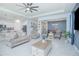 Spacious living room features modern decor, comfortable seating, ceiling fan, and flows into dining and kitchen areas at 1636 Barberry Dr, Kissimmee, FL 34744