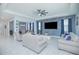 Comfortable living room with a large TV, stylish accent wall, and open layout to the dining area at 1636 Barberry Dr, Kissimmee, FL 34744