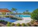 Beautiful community pool area with lounge chairs, palm trees, and a covered seating area for relaxing by the water at 1636 Barberry Dr, Kissimmee, FL 34744