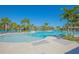 Community pool with shallow entry, lounge chairs, and palm trees offering a relaxed atmosphere at 1636 Barberry Dr, Kissimmee, FL 34744