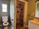 Bathroom features shower, toilet, vanity and sink with green walls showing water damage at 1754 Lake St, Oviedo, FL 32765