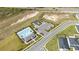 Aerial view of the community pool, playground, parking area, and surrounding green spaces at 1760 Astrid Rd, Davenport, FL 33837