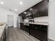 Modern kitchen showcasing dark cabinets, stainless steel appliances, and granite countertops at 1760 Astrid Rd, Davenport, FL 33837