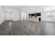 Bright, open-concept living space with gray floors flowing into kitchen featuring a central island at 1760 Astrid Rd, Davenport, FL 33837