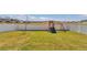 Spacious backyard with white fence, lush lawn, and playset at 1795 Nw 44Th Ct Rd, Ocala, FL 34482