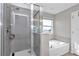 Bright bathroom showcasing a tiled shower, separate soaking tub, and a window for natural light at 1795 Nw 44Th Ct Rd, Ocala, FL 34482
